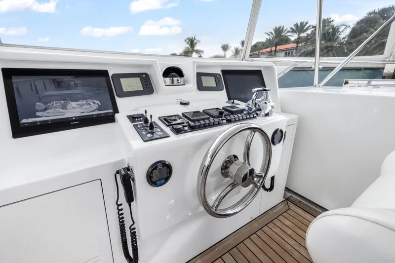 Jus Chill'n Yacht Photos Pics Helm of 2012 Cheoy Lee 84 Bravo yacht with modern navigation equipment and steering wheel.