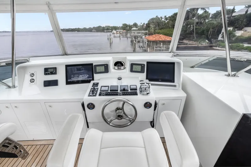Jus Chill'n Yacht Photos Pics Helm of 2012 Cheoy Lee 84 Bravo yacht with modern navigation equipment and scenic water view.