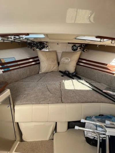  Yacht Photos Pics 2020 Grady-White Express 330 cabin interior with fishing rods and cushions.