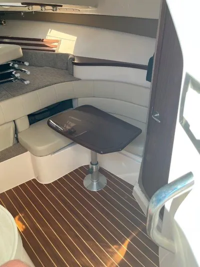  Yacht Photos Pics 2020 Grady-White Express 330 cabin interior with seating and table, featuring wood flooring.