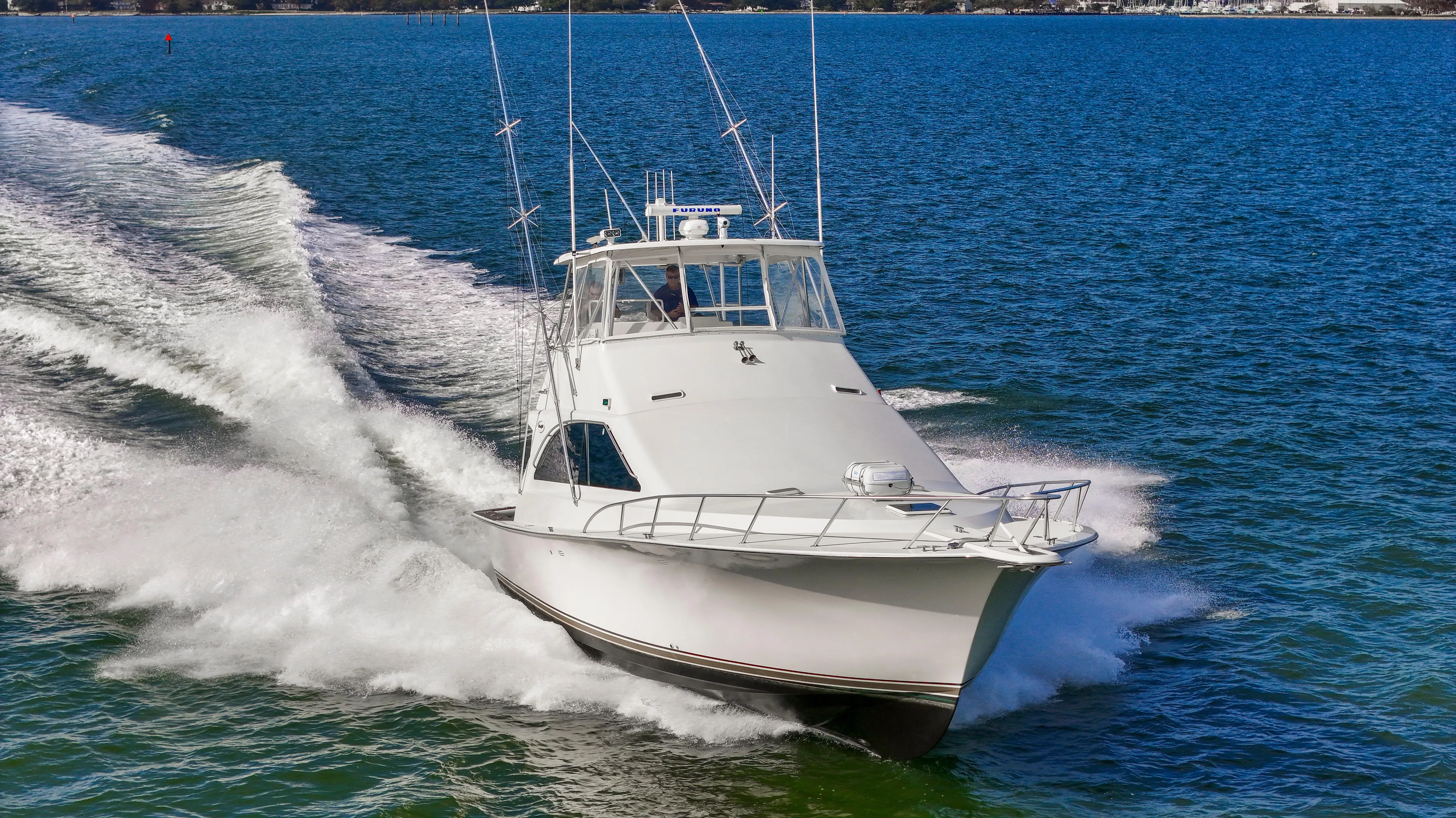 Event Horizon Yacht Photos Pics Ocean Yachts 48 Super Sport 2000 cruising on open water, creating a dynamic wake.