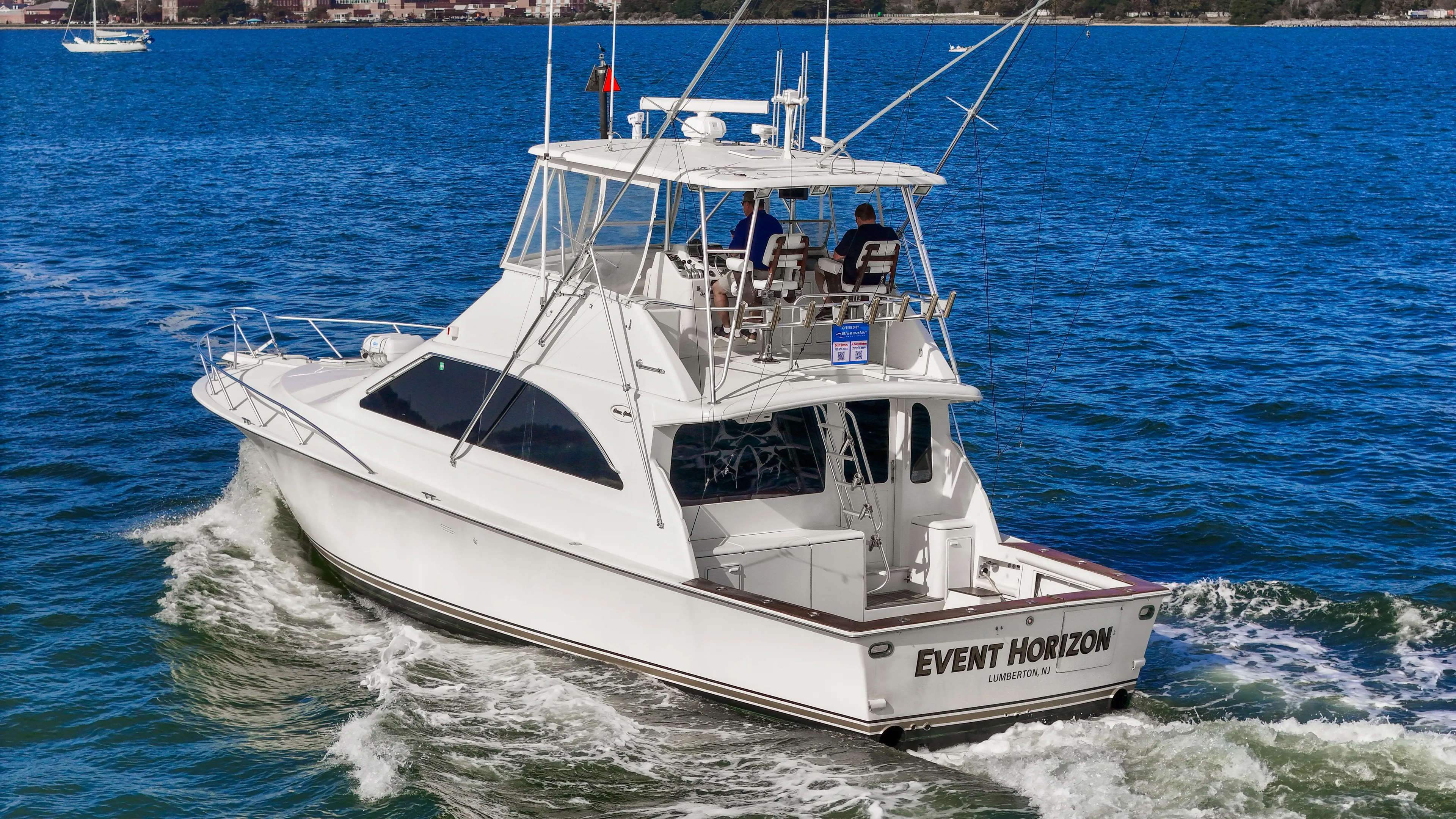 Event Horizon Yacht Photos Pics Ocean Yachts 48 Super Sport 2000 cruising on blue water, rear view.