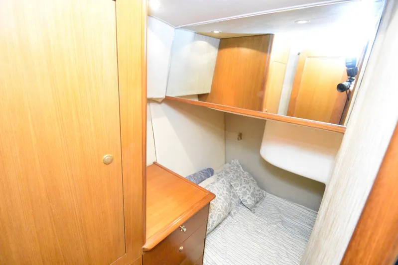 Event Horizon Yacht Photos Pics Cozy cabin interior of 2000 Ocean Yachts 48 Super Sport with wooden cabinetry and bedding.