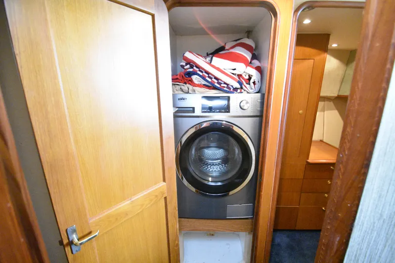 Event Horizon Yacht Photos Pics Laundry area with washer in 2000 Ocean Yachts 48 Super Sport.