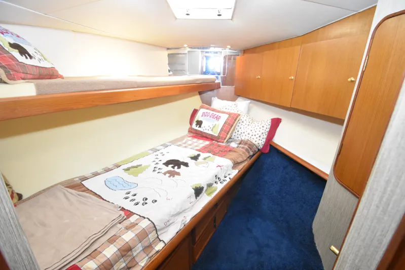 Event Horizon Yacht Photos Pics Cozy cabin interior of 2000 Ocean Yachts 48 Super Sport with bunk beds and wooden cabinets.