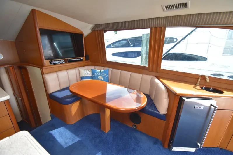 Event Horizon Yacht Photos Pics Luxurious interior of 2000 Ocean Yachts 48 Super Sport with seating, table, and mini fridge.
