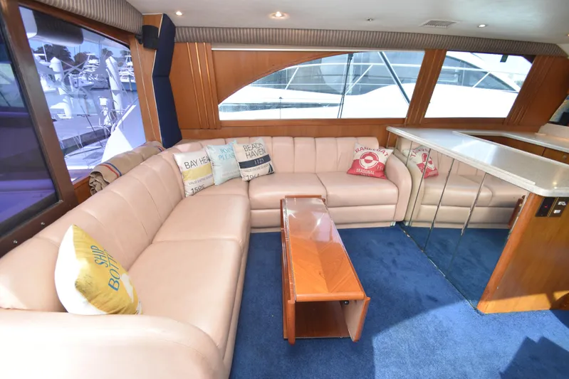 Event Horizon Yacht Photos Pics Luxurious interior of a 2000 Ocean Yachts 48 Super Sport with plush seating and nautical decor.