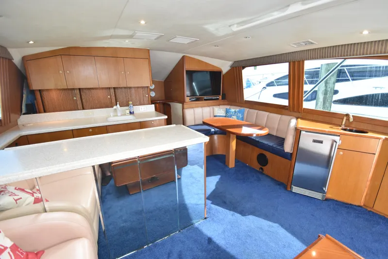 Event Horizon Yacht Photos Pics Luxurious interior of 2000 Ocean Yachts 48 Super Sport with modern amenities and seating.