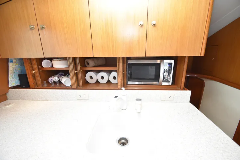 Event Horizon Yacht Photos Pics Kitchen area of 2000 Ocean Yachts 48 Super Sport with cabinets and microwave.
