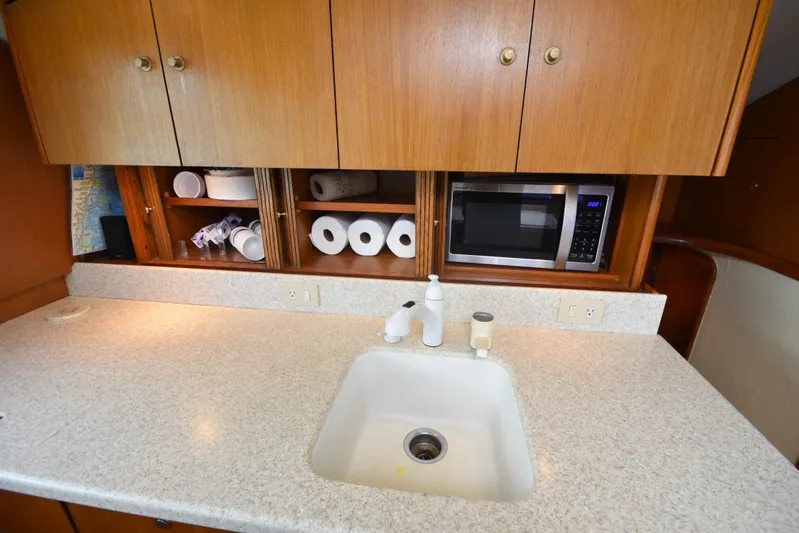 Event Horizon Yacht Photos Pics Kitchen area of 2000 Ocean Yachts 48 Super Sport with sink, microwave, and storage.
