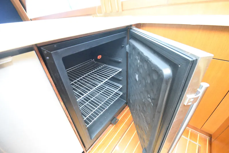 Event Horizon Yacht Photos Pics Open refrigerator on 2000 Ocean Yachts 48 Super Sport, showcasing interior shelves.