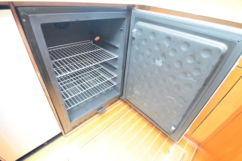 Event Horizon Yacht Photos Pics Open refrigerator with wire shelves on Ocean Yachts 48 Super Sport, 2000 model.