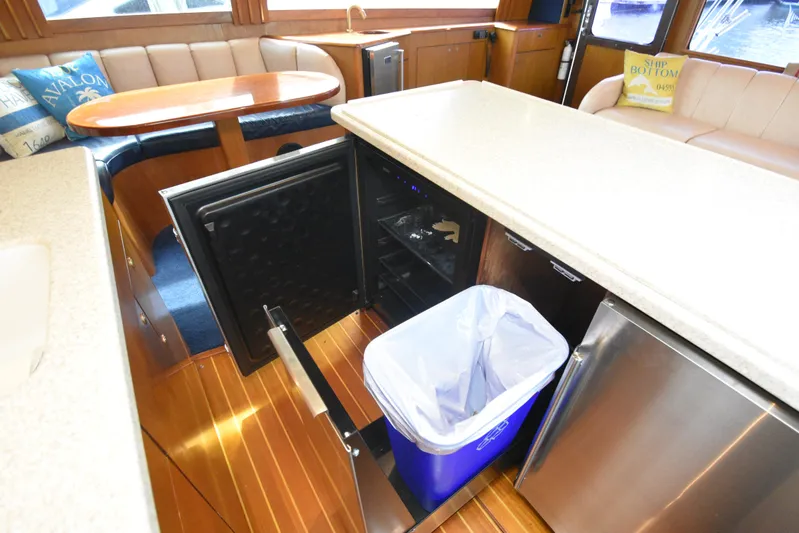 Event Horizon Yacht Photos Pics Interior of 2000 Ocean Yachts 48 Super Sport with open fridge and trash bin.