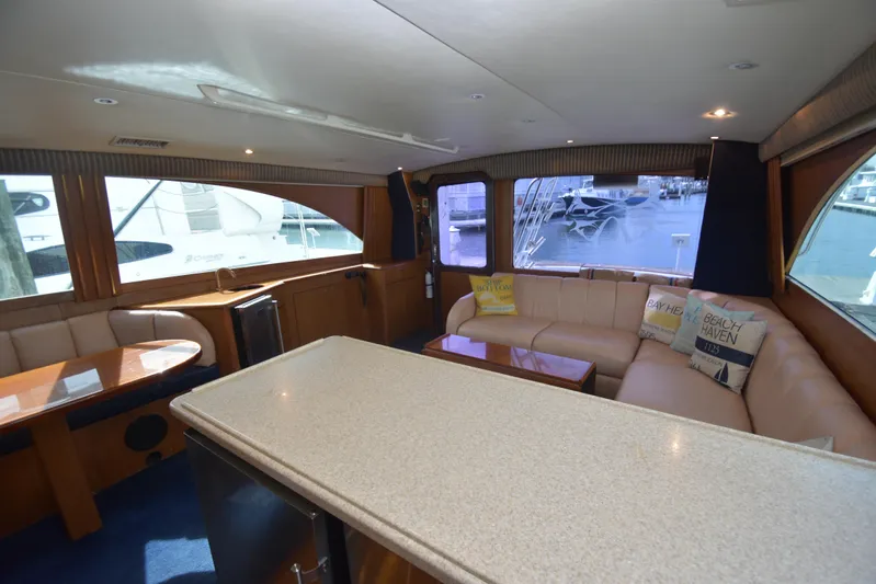 Event Horizon Yacht Photos Pics Luxurious interior of 2000 Ocean Yachts 48 Super Sport with plush seating and large windows.