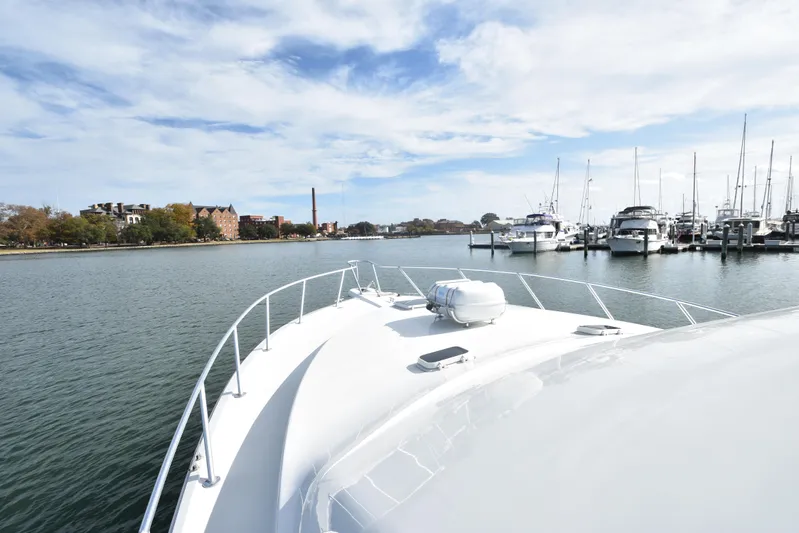 Event Horizon Yacht Photos Pics Bow view of 2000 Ocean Yachts 48 Super Sport approaching marina with docked boats.