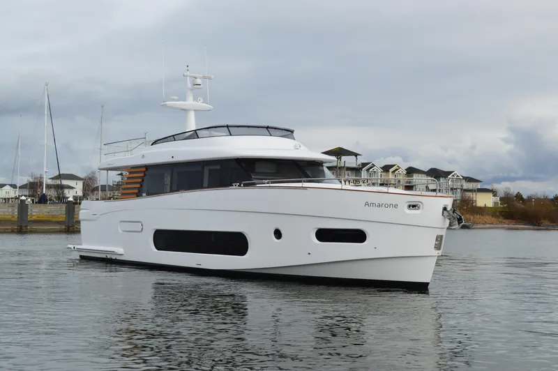  Yacht Photos Pics 2023 Azimut Magellano 66 yacht on calm water near a marina.