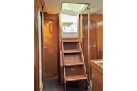 Interior of 2009 Dufour 45E Performance yacht with wooden stairs and doors.