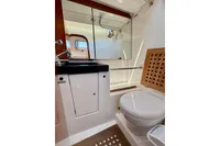 Bathroom interior of 2009 Dufour 45E Performance yacht, featuring modern fixtures and wooden accents.