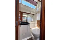 Interior of 2009 Dufour 45E Performance yacht bathroom with sink, mirror, and toilet.