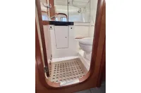 Bathroom interior of 2009 Dufour 45E Performance yacht, featuring wooden accents and modern fixtures.