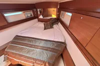 Luxurious cabin interior of 2009 Dufour 45E Performance yacht with cozy bedding.