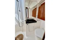 Bathroom interior of 2009 Dufour 45E Performance yacht with modern fixtures and wooden cabinetry.