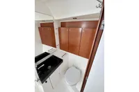 Bathroom interior of 2009 Dufour 45E Performance yacht with wooden cabinets and modern fixtures.