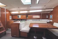 Interior of 2009 Dufour 45E Performance yacht with wooden finish and cozy seating area.