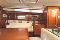 Luxurious interior of 2009 Dufour 45E Performance yacht with elegant wood finish and plush seating.