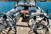 Cockpit of 2009 Dufour 45E Performance sailboat with dual steering wheels and wooden deck.