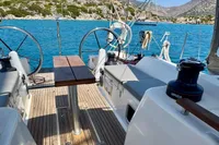 Dufour 45E Performance 2009 sailboat cockpit with dual steering wheels, docked in scenic bay.