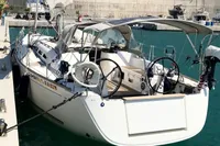 2009 Dufour 45E Performance yacht docked in a marina, featuring dual steering wheels.