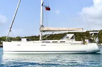 2009 Dufour 45E Performance sailboat with Turkish flag, anchored in calm waters.