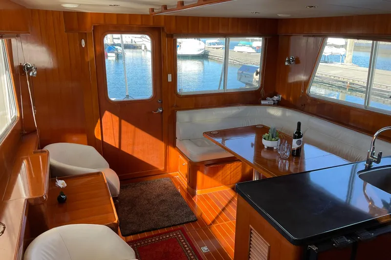 Mariposa Yacht Photos Pics Luxurious 2012 Integrity 45 yacht interior with wood paneling and marina view.