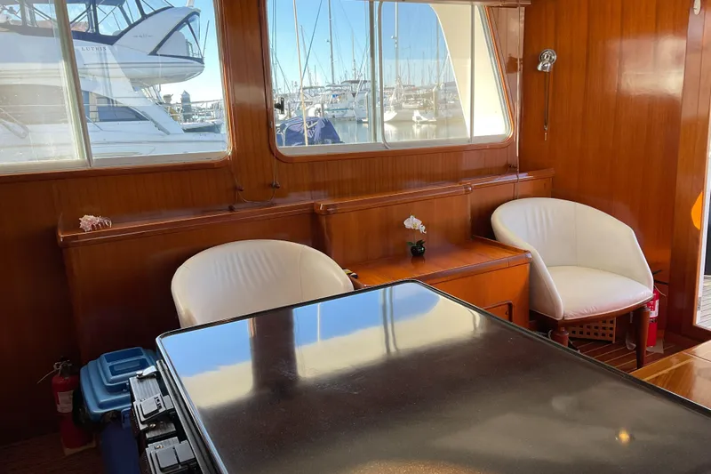 Mariposa Yacht Photos Pics Interior of 2012 Integrity 45 yacht with wooden paneling and white chairs.