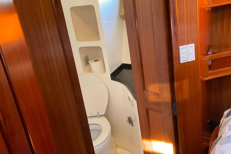 Mariposa Yacht Photos Pics Compact bathroom in 2012 Integrity 45 yacht with wooden cabinetry and modern fixtures.