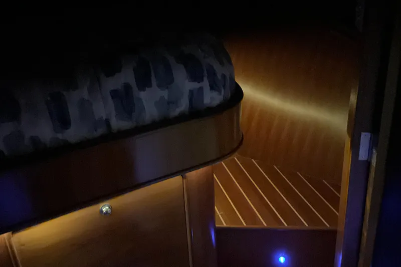 Mariposa Yacht Photos Pics Dimly lit cabin interior of 2012 Integrity 45 yacht with wooden flooring and cozy bedding.