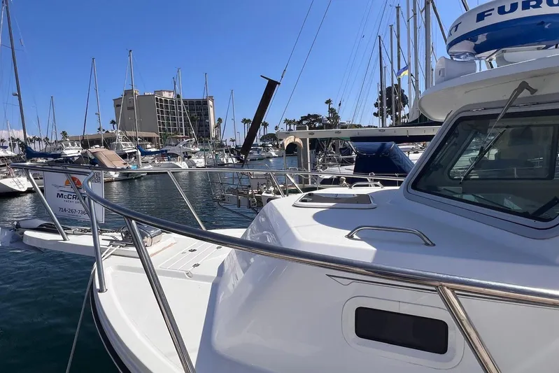 Sd Jam Yacht Photos Pics 2023 Parker 2820 XLD Sport Cabin boat docked in marina, surrounded by sailboats.