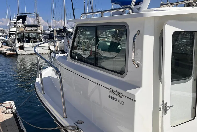 Sd Jam Yacht Photos Pics 2023 Parker 2820 XLD Sport Cabin boat docked at marina, side view.
