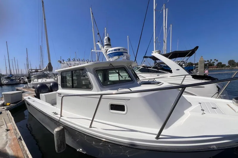 Sd Jam Yacht Photos Pics 2023 Parker 2820 XLD Sport Cabin boat docked at marina with clear blue sky.