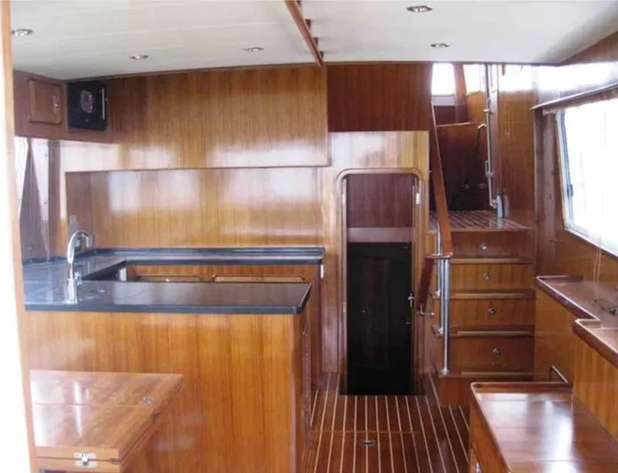 Mariposa Yacht Photos Pics 2012 Integrity 45 yacht interior with wooden cabinetry and black countertops.
