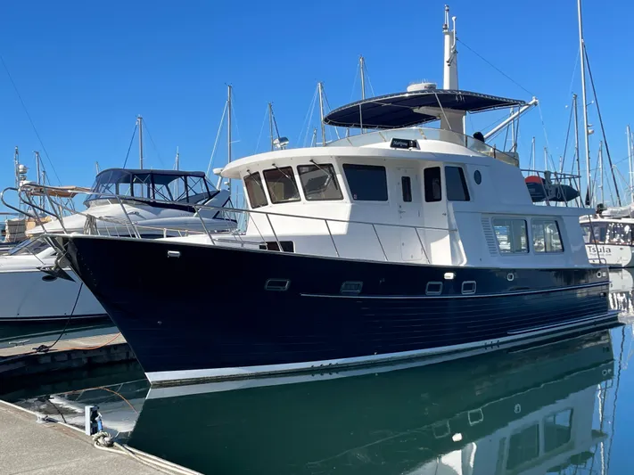 Mariposa Yacht Photos Pics Integrity 45 yacht, 2012 model, docked at marina with clear blue sky.