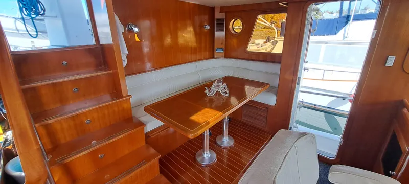 Mariposa Yacht Photos Pics Luxurious interior of a 2012 Integrity 45 yacht with wooden finishes and cozy seating area.
