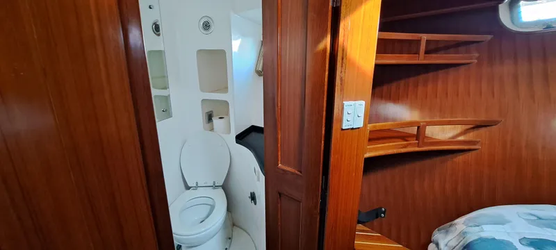 Mariposa Yacht Photos Pics Interior of 2012 Integrity 45 boat showing bathroom and wooden cabin.