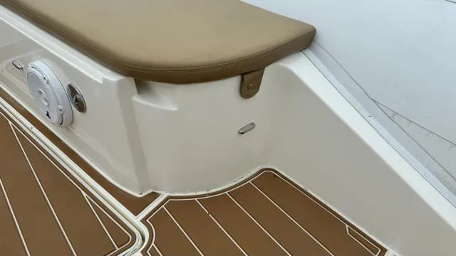 Hoko Yacht Photos Pics Nuova Jolly Princess 2017 boat interior with brown cushioned seating and wood-patterned flooring.