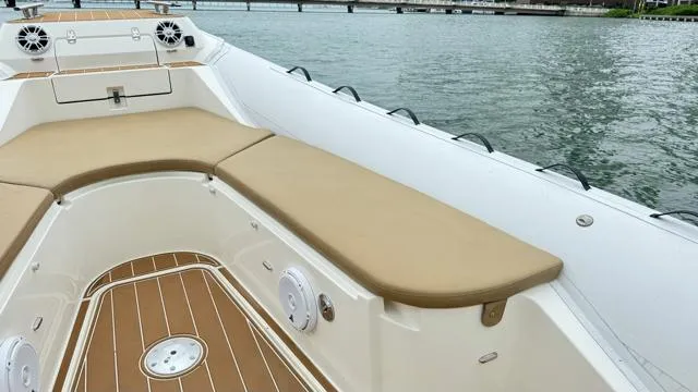 Hoko Yacht Photos Pics 2017 Nuova Jolly Princess boat with tan seating and wood deck on calm water.