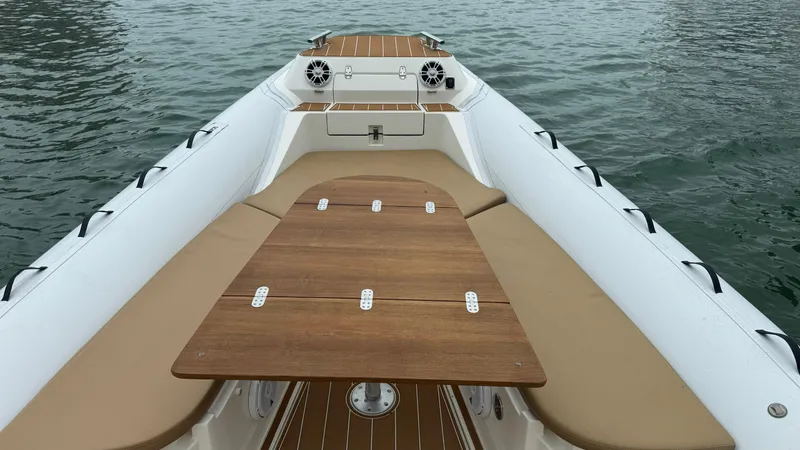 Hoko Yacht Photos Pics 2017 Nuova Jolly Princess boat with wooden deck and beige seating on water.