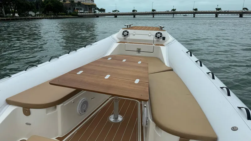 Hoko Yacht Photos Pics 2017 Nuova Jolly Princess boat interior with wooden table and beige seating.