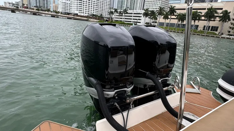 Hoko Yacht Photos Pics Twin outboard motors on a 2017 Nuova Jolly Princess boat, docked in a city marina.