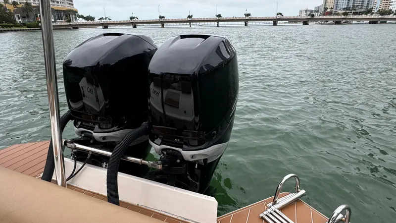 Hoko Yacht Photos Pics 2017 Nuova Jolly Princess boat with dual outboard motors on a calm waterway.